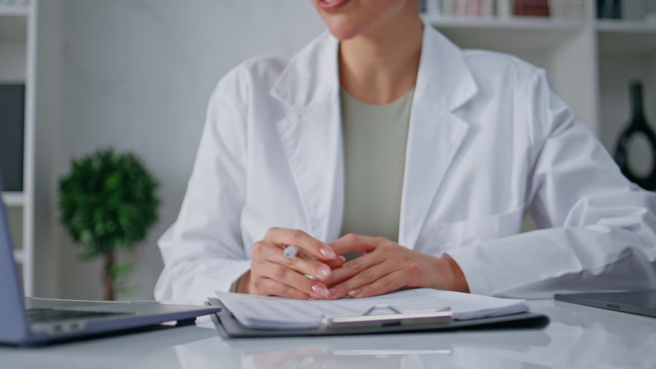 Physician discussing therapy remote consultation at clinic table closeup