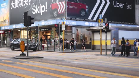 traffic and pedestrians at a bustling intersection