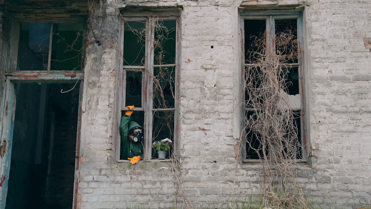 Man with gas mask in destroyed building. Man wearing protective suit and mask against radioactive environment