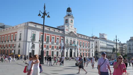 bustling puerta del sol square in madrid with historic building and crowds