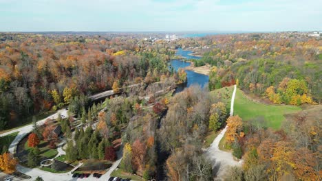 drone flying over a river on a sunny autumn day in ontario