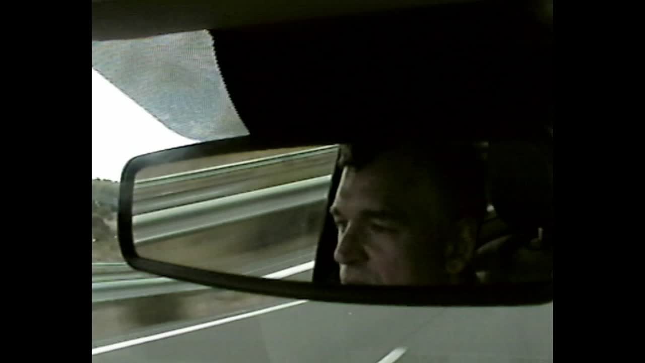 Man in car mirror reflection