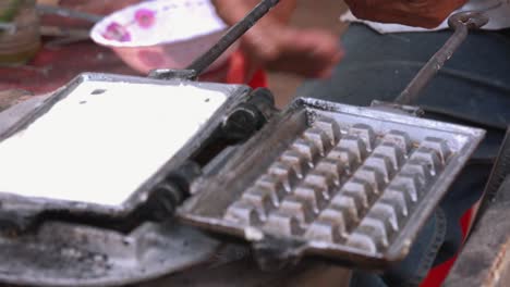 Close-Exterior-Shot-of-Ladling-Waffle-Batter-into-Hot-Waffle-Iron-and-Closing-on-Roadside-Stall