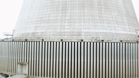 Drone-flight-upwards-along-the-giant-structure-of-a-cooling-tower-of-a-coal-power-plant-in-Europe