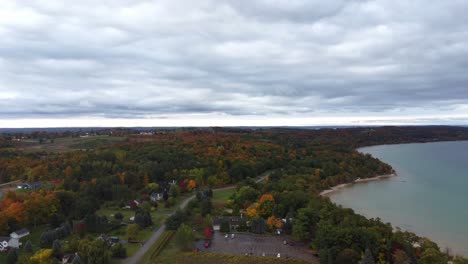 aerial shot of northern lake in the fall with forest