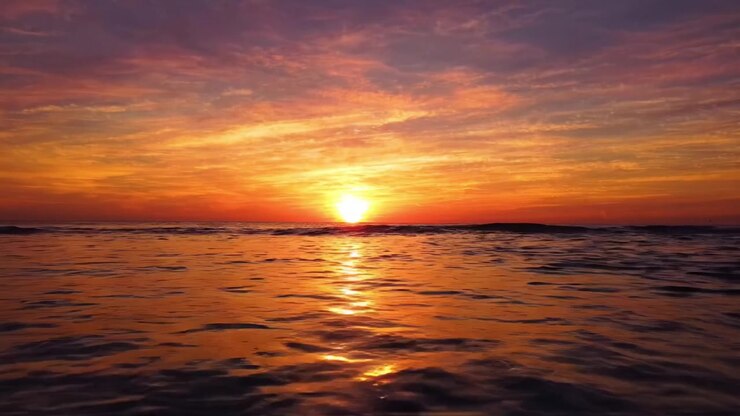 Breathtaking Sunset Over Calm Ocean Waves Captured in Two Stunning Frames: A Serene Evening of Vibrant Colors and Peaceful Waters
