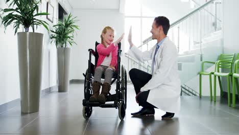 doctor giving high five to disable girl