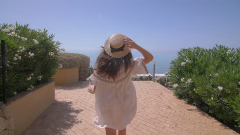 woman in a hat enjoying a beach vacation