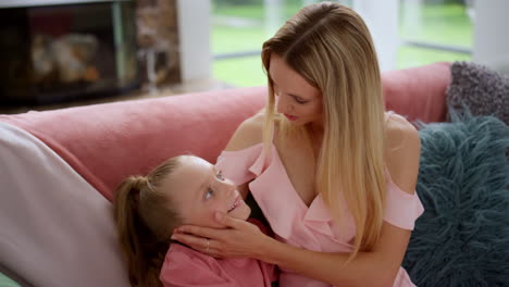 Portrait-of-young-mother-looking-at-her-daughter