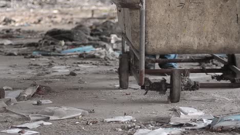 pushing a cart through rubble in abandoned derelict mill