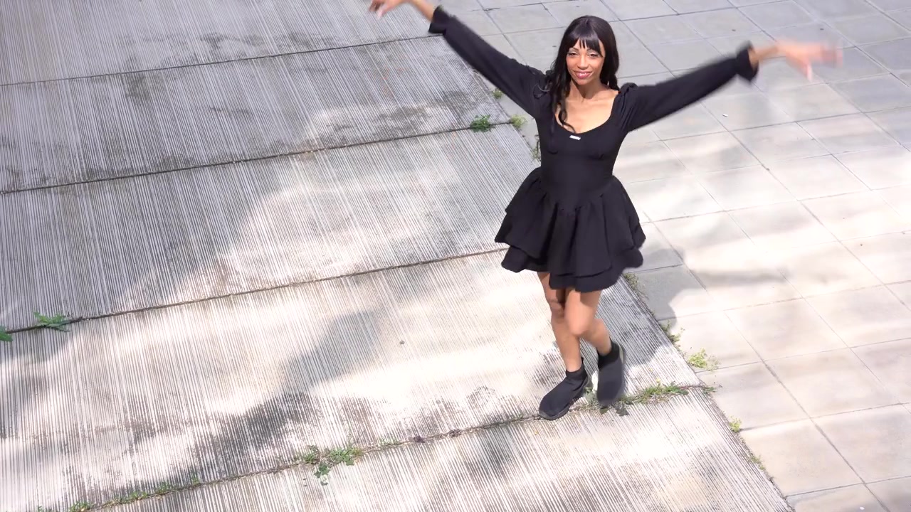 Young black woman dancing in the street