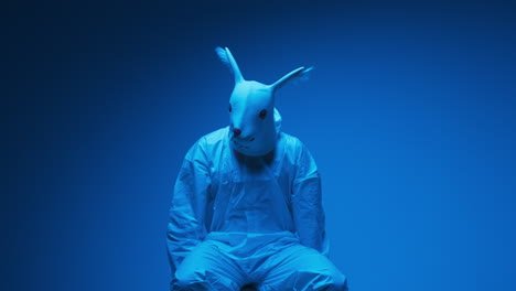 person in rabbit mask and protective suit