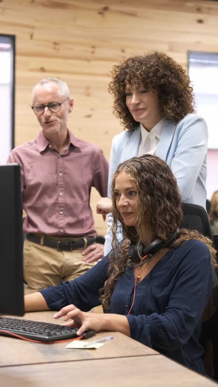 Managers coaching customer service representative. Vertical footage