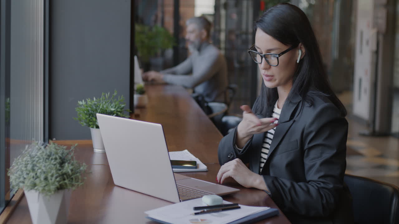 Business Woman on Video Call in a Coffee Shop