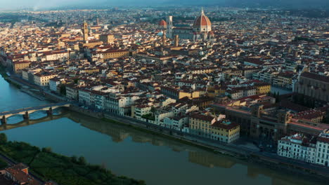 aerial view of arno river, tilt reveals florence cathedral