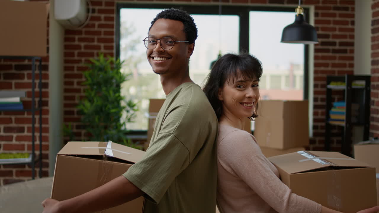 Portrait of multiethnic couple moving in rented flat together