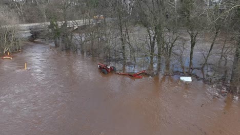 tractor submerged in flood water. natural disaster theme