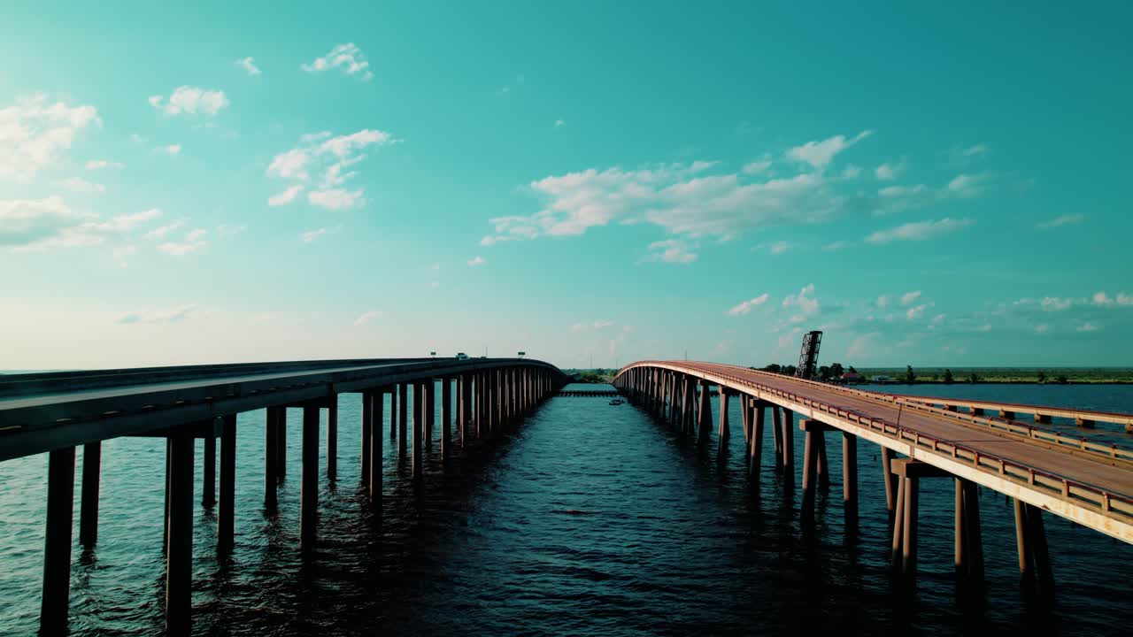 Frontal drone view of Manchac Swamp Bridge extending across open water and wetlands