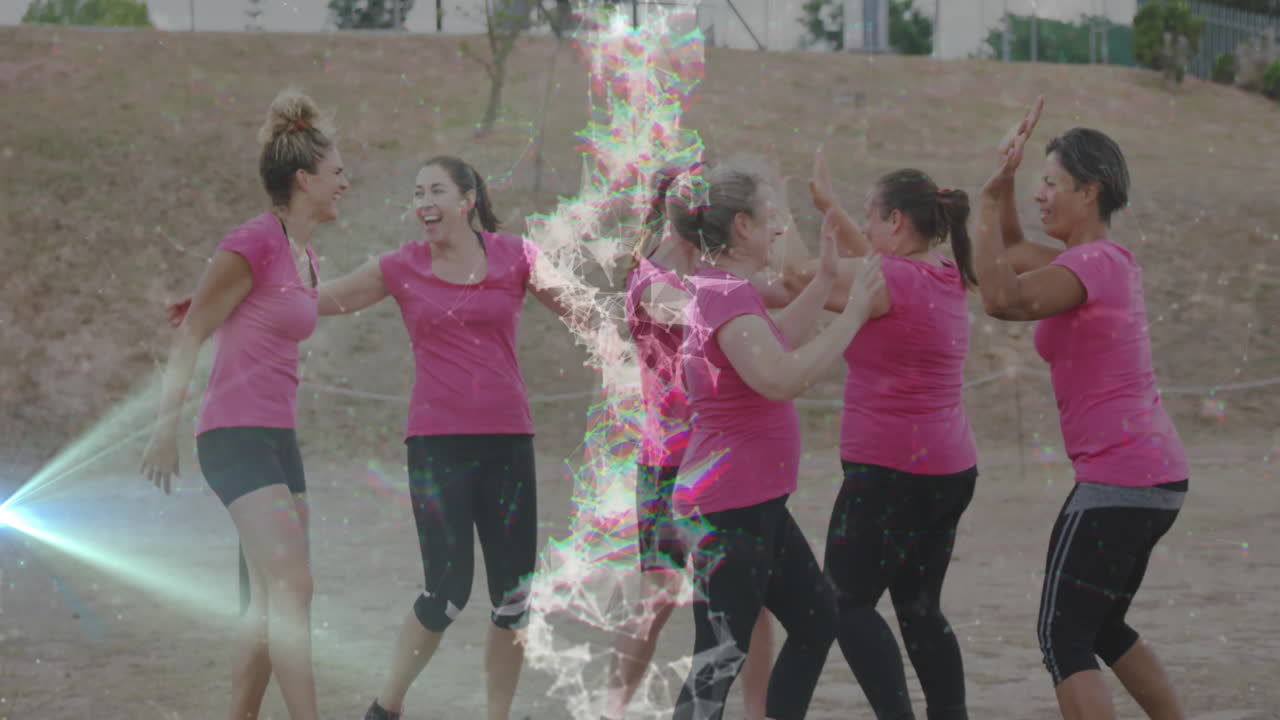 Women in pink shirts celebrating outdoors with colorful digital animation overlay