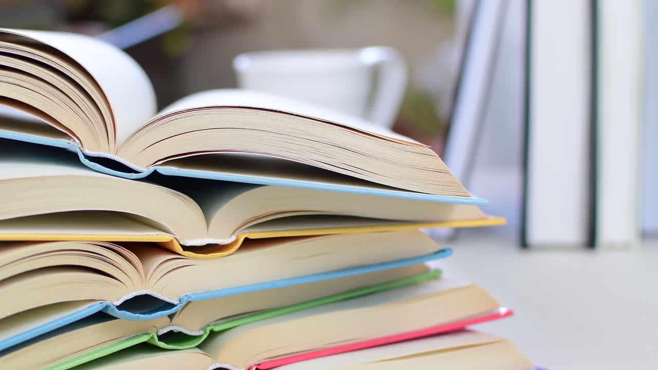A stack of books with different colored spines
