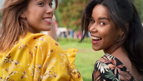 Young-friends-dancing-and-walking-together-at-the-music-festival.