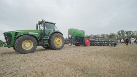 demonstration of agricultural machinery at an exhibition. tractors operate in the field, showcasing their capabilities and performance in action