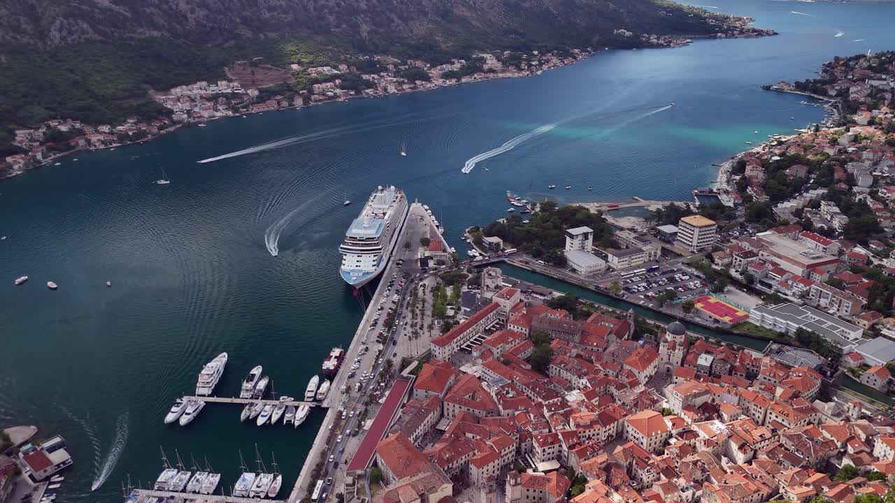Mtn aerial descends to Kotor Montenegro old town and cruise ship pier