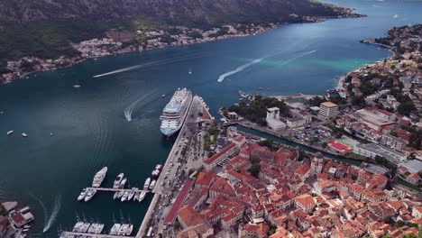 mtn aerial descends to kotor montenegro old town and cruise ship pier