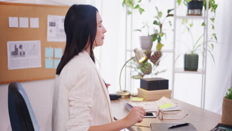 confident businesswoman stretches while working in office