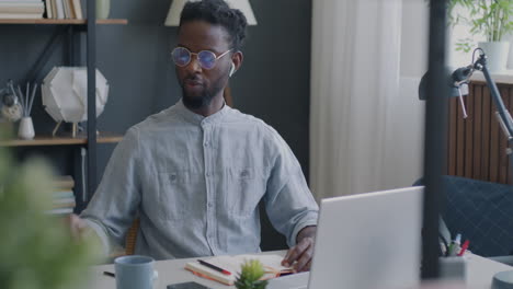 man in video call, holding a document.