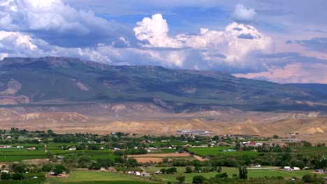 grand mesa grand junction aerial drone afternoon cloudy colorado river summer blue sky wine vineyards parachute fruitvale mt garfield western close delta downtown main street pan right motion