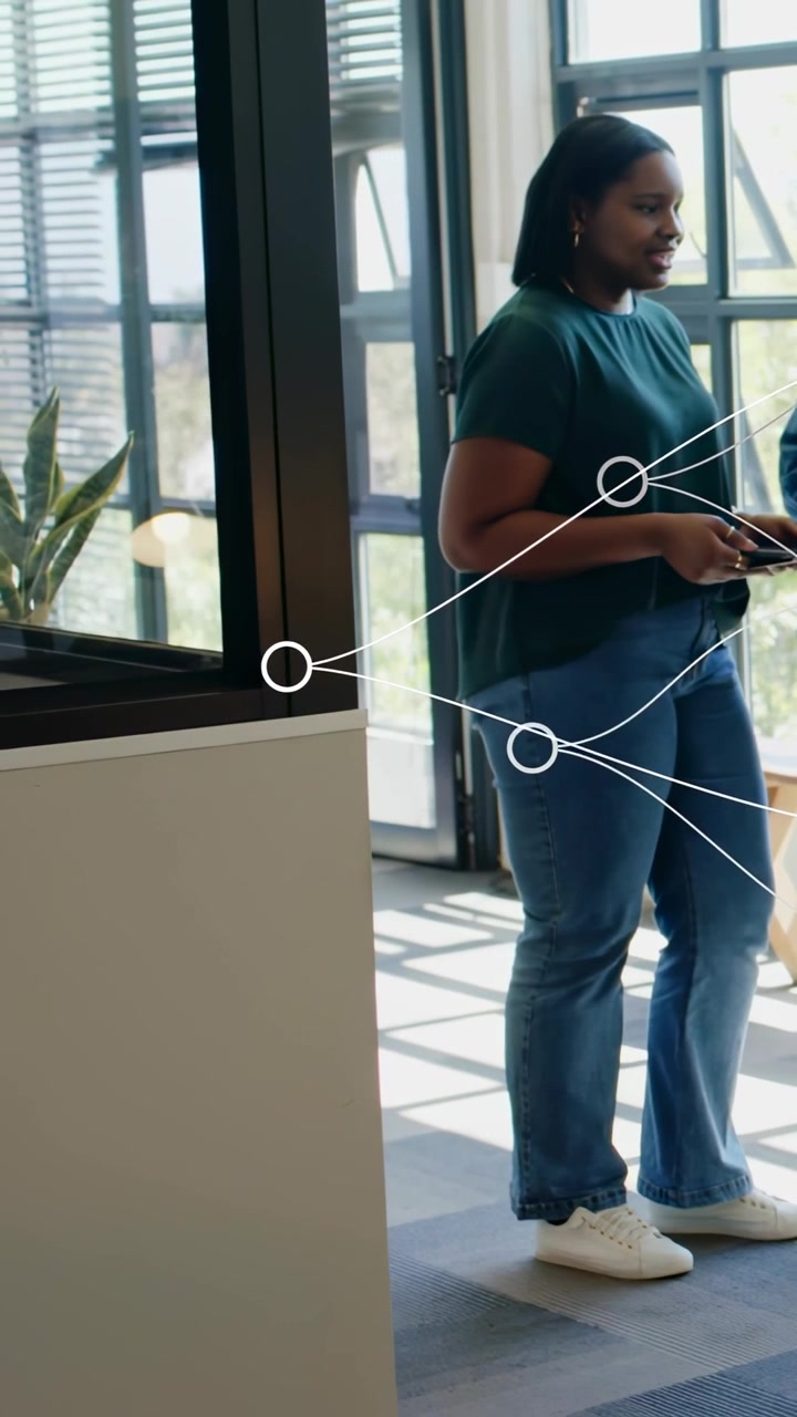 Vertical video: Woman tapping tablet, sharing business data with peer, white nodes highlighting