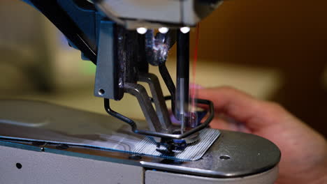 woman using sewing machine in factory
