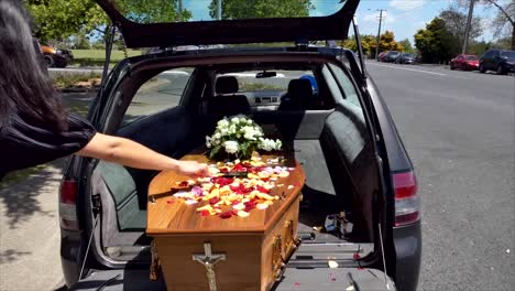 closeup shot of a funeral casket in a hearse or chapel or burial at cemetery