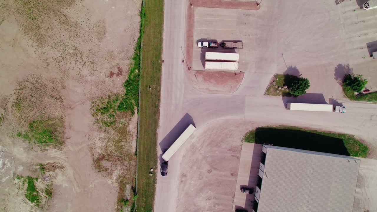Aerial View of Trucks Maneuvering at a Logistics Facility
