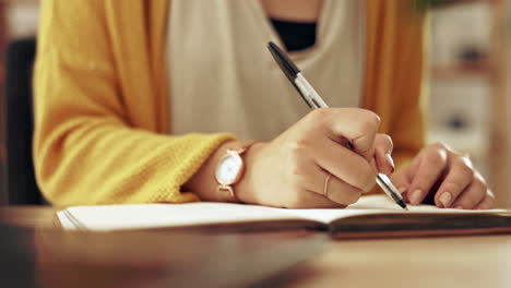 woman, hand and writing in a notebook at home