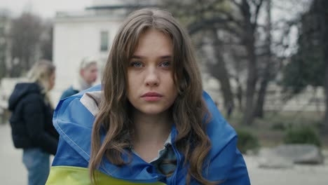 woman in front of group of young caucasian people manifesting against war in ukraine.