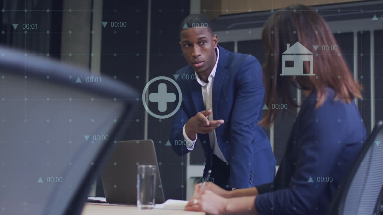 Animation of media icons and data processing over diverse colleagues using laptop in office