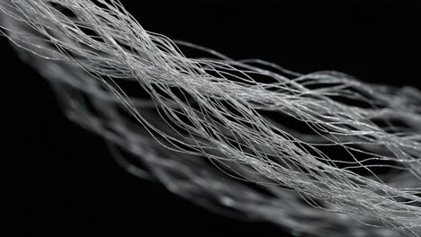 intricate details of fine fibers captured in motion: a close-up exploration of translucent strands in artistic arrangement against a dark background