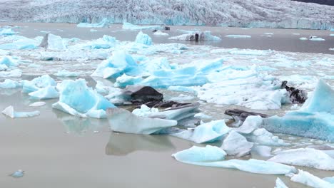 pieces of iceberg floating in water due to rapidly melting glaciers caused by global warming