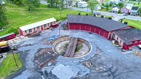 An-Aerial-View-of-an-Abandoned-Narrow-Gauge-Coal-Rail-Road-with-Rusting-Hoppers-and-Freight-Cars-and-Support-Building-Starting-to-be-Restored