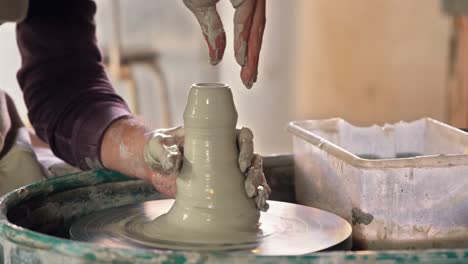 male potter making pot