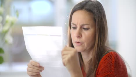 cu of stressed woman reading mail