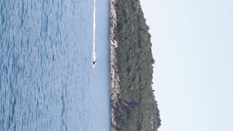jet ski racing in the crystal clear adriatic sea with the otok lokrum island in the background in dubrovnik, croatia