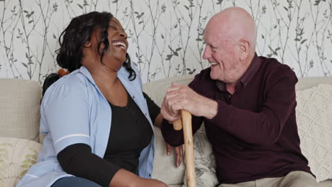 caregiver and senior sharing a laugh