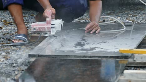 man cutting granite stone