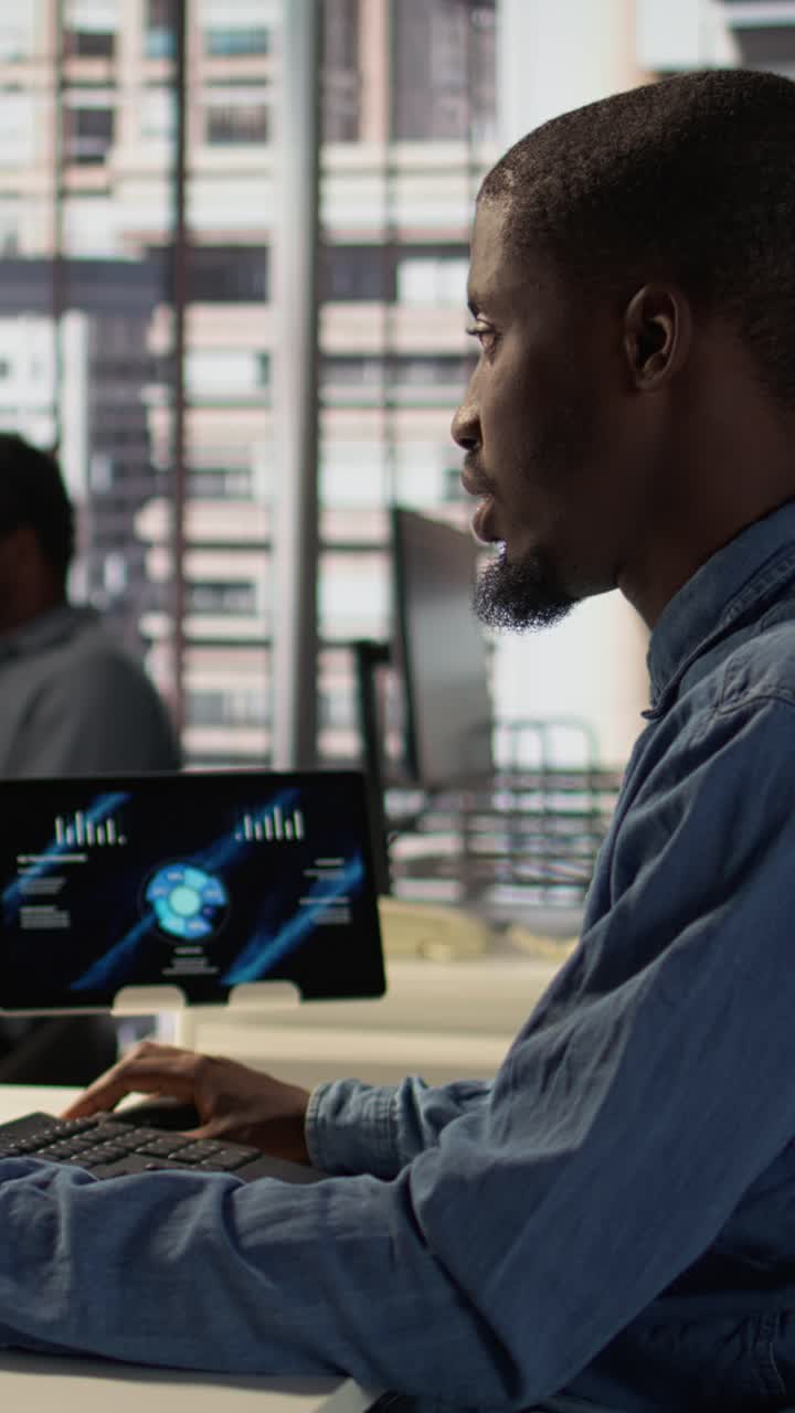 African American Man Working on Tablet and Keyboard in Modern Office