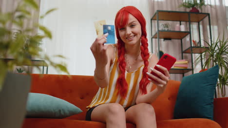 Redhead-girl-show-plastic-credit-bank-card-advertising-transferring-money-cashless-online-shopping