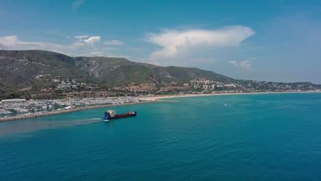 Industrial-ship-leaving-a-trail-of-pollution-on-coast-of-Garraf,-Catalonia