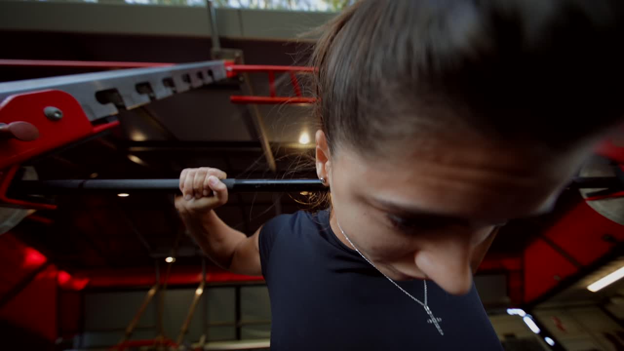 Woman exercising on a pull-up bar